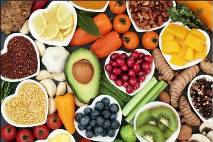 Colorful assortment of fresh fruits, vegetables, nuts, and superfoods for healthy balanced nutrition.