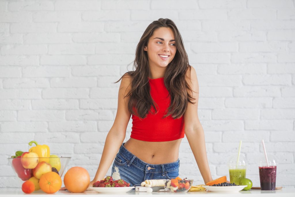 Woman enjoying fresh fruits, healthy snacks, and nutritious drinks as part of a balanced lifestyle.