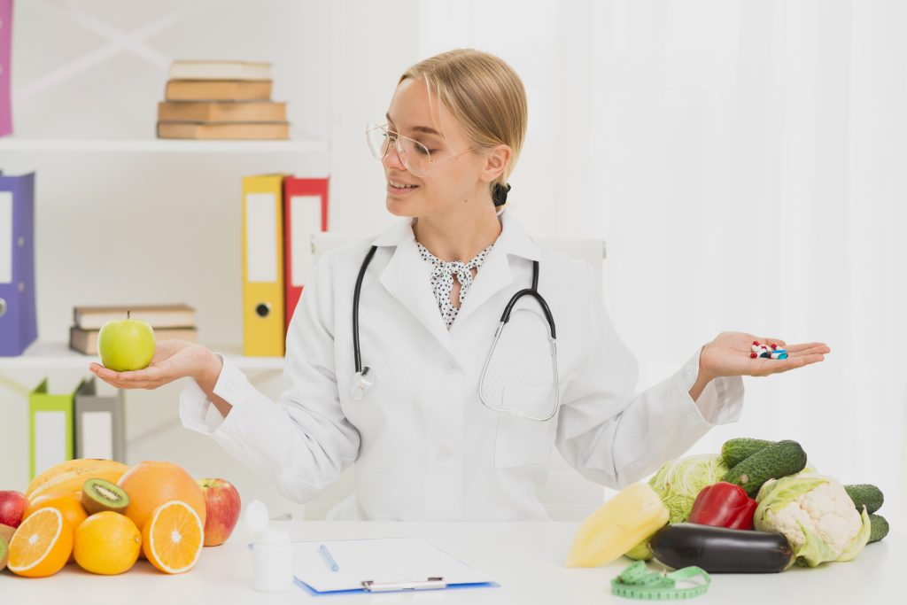 Nutrition expert choosing healthy fruits over pills while promoting natural food and balanced nutrition.