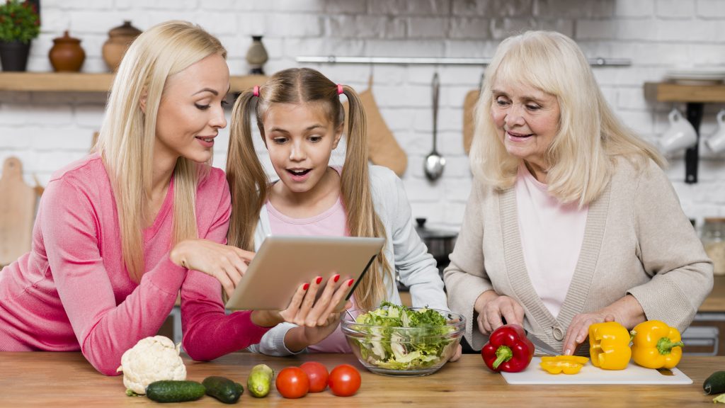Family preparing healthy meals with fresh vegetables while learning about balanced nutrition together.